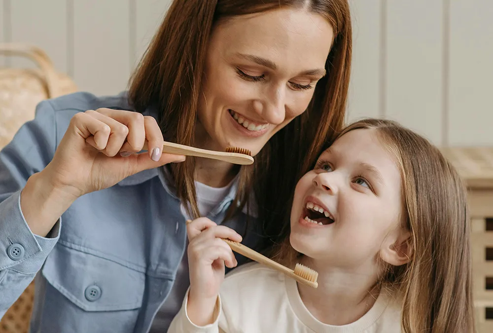 Mom and kid brushes teeth